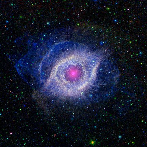 A dying star throws a cosmic tantrum in this combined image from Nasa's Spitzer Space Telescope and the Galaxy Evolution Explorer. The star's dusty outer layers are unraveling into space, glowing from the intense ultraviolet radiation being pumped out by the hot stellar core. This object, called the Helix nebula, lies 650 light years away in the constellation of Aquarius