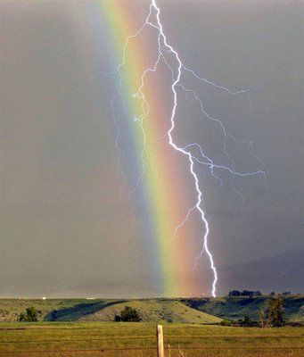 A lightning bolt strikes through a rainbow during a thunderstorm over Sheridan, Wyo., on June 15, 2005.