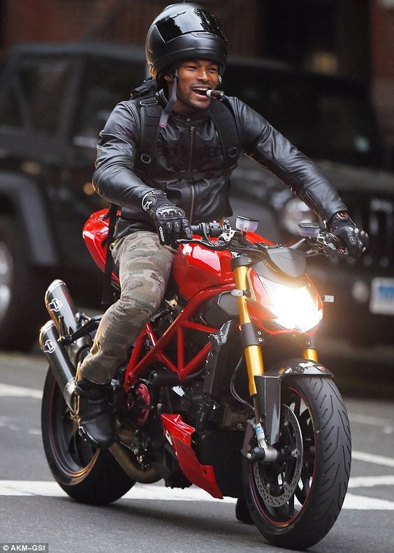 Born to be wild! Tyson Beckford, 43, was seen riding atop his motorbike while not completely wearing his helmet and smoking a cigar in the West Village neighbourhood of New York on Thursday