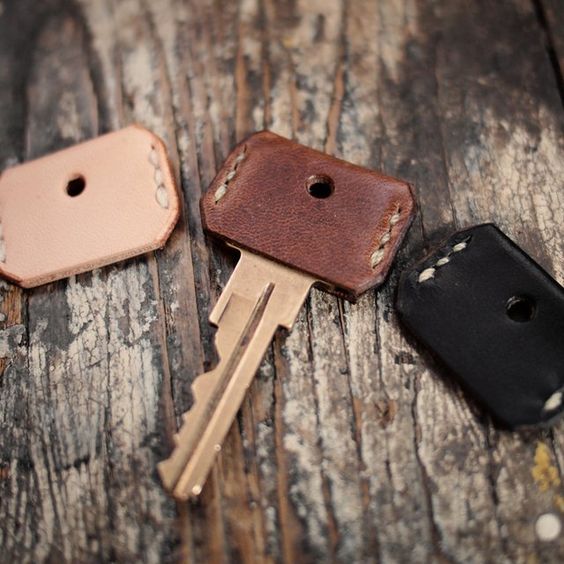 Buy small strips of leather and cut out key covers for all your keys, sew the sides and cut out a whole for the key ring.
