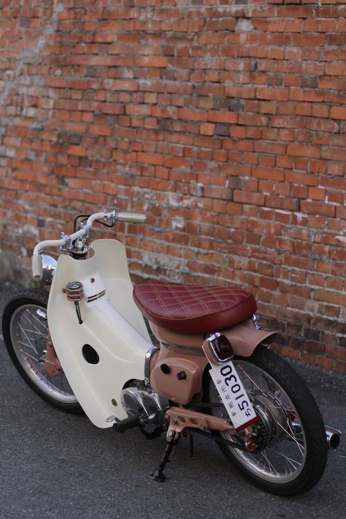 custom Honda Cub with maroon quilted seat