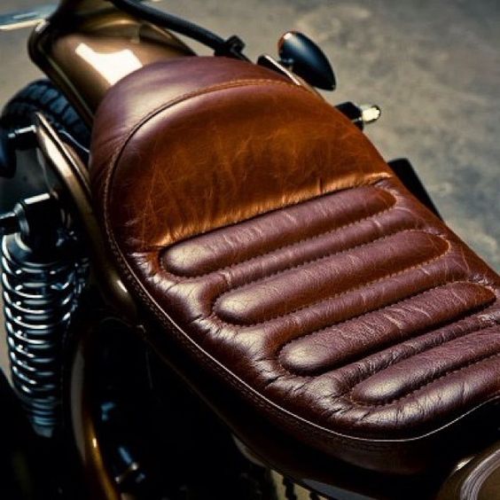 custom leather motorcycle seat out a beautiful rich leather and including some cool looking pillow pleating.