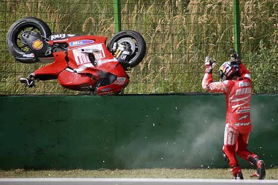 Ducati's Mika Kallio of Finland reacts after crashing during the classification session for the Czech Grand Prix.