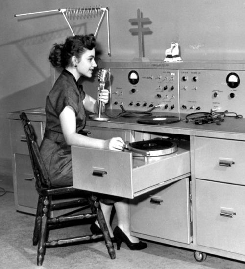 Female DJ spinning records, 1950s