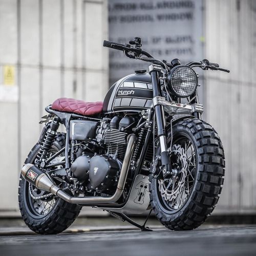 For extroverts only: this new Triumph T100 from @downandoutcaferacers has a truckload of attitude.  The stance is belligerent, helped by the chunky Continental Twinduro TKC80 rubber—one of the few dual sport tires that perform well on pavement.  There’s no way that sort of rubber would normally fit between the forks of a standard T100. But builders Shaun and Carl have neatly solved that problem, by installing Honda CBR1000RR (Fireblade) forks and a set of custom triple trees.  Hit the link