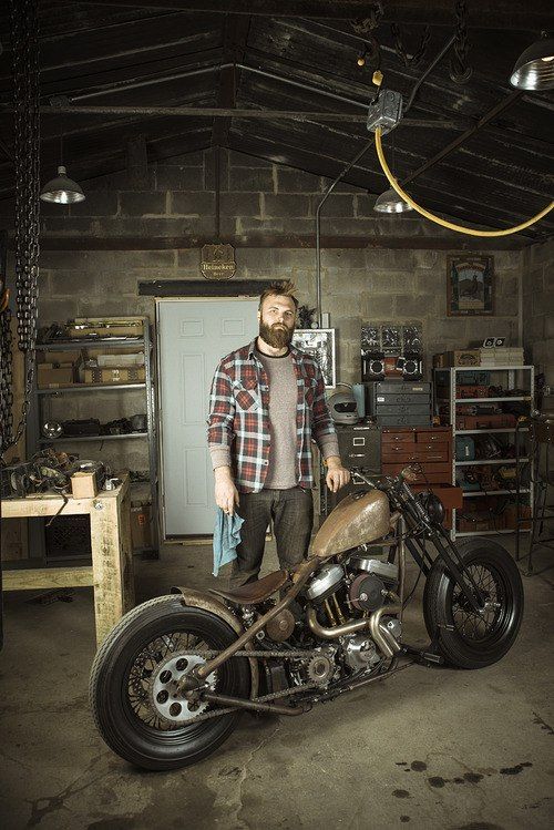 Harley Davidson bobber, built in his garage. That is one sexy man with his Harley.