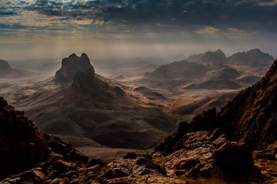 In this beautiful photograph by Brigitte Djajasasmita we see the Hoggar Mountains of Algeria. The Hoggar Mountains, also known as the Ahaggar, are a highland region in central Sahara, or southern Algeria, along the Tropic of Cancer. They are located about 1,500 km (900 mi) south of the capital, Algiers and just west of Tamanghasset.