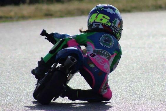 Mini moto racing… a little girl sporting a Rossi ‘46’ AGV helmet, full leathers, getting her knee down! How amazing is 