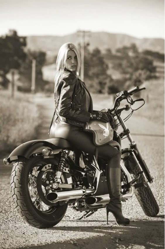 Motorcycle Girl Photo of Playboy Playmate Heather Rae Young Wearing a Leather Motorcycle Jacket, High Leather Boots and a Playboy Motorcycle Helmet - Sitting on a Harley-Davidson