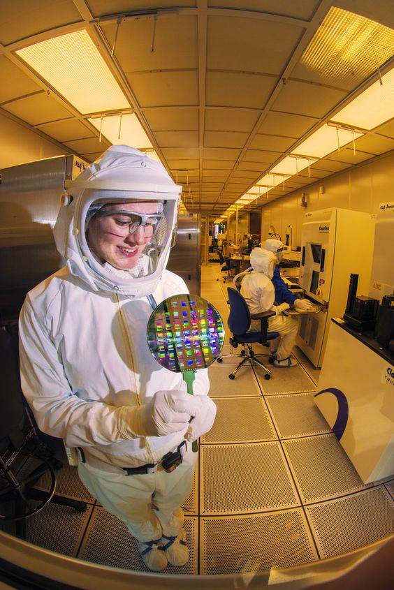 #Sandia #microelectronics technician Patty Chenevey studies a wafer, a thin slice of semiconductor material used in the fabrication of microdevices. Chenevey specializes in microlithography. She patterns small-scale structures on a wafer. “I enjoy what I do because it allows me to work with leading researchers to fabricate cutting-edge devices, solve practical engineering issues and explore fundamental science questions,” she says.   Photo by Randy Montoya.