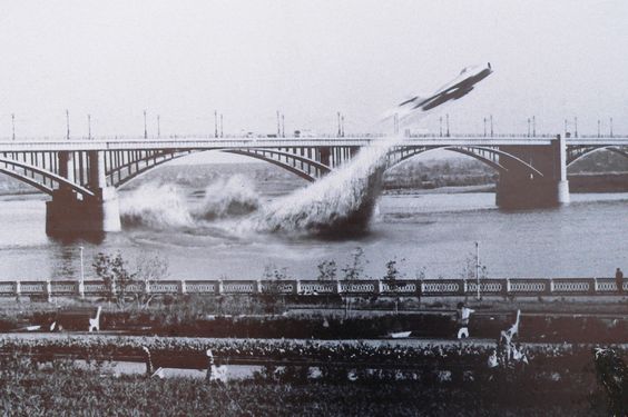 Soviet Air Force pilot Valentin Privalov flies his jet fighter under a bridge on the river Ob, in Siberia, June 4th, 1965.