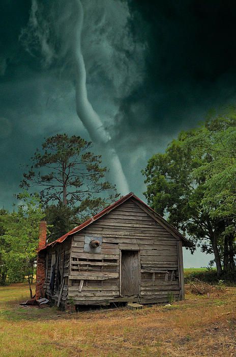 The photographer commented that she rode the tornado out in a ditch that was close, and that most of the building was left standing, but the tin roof was probably in the next county.  She didn't say where this was taken.