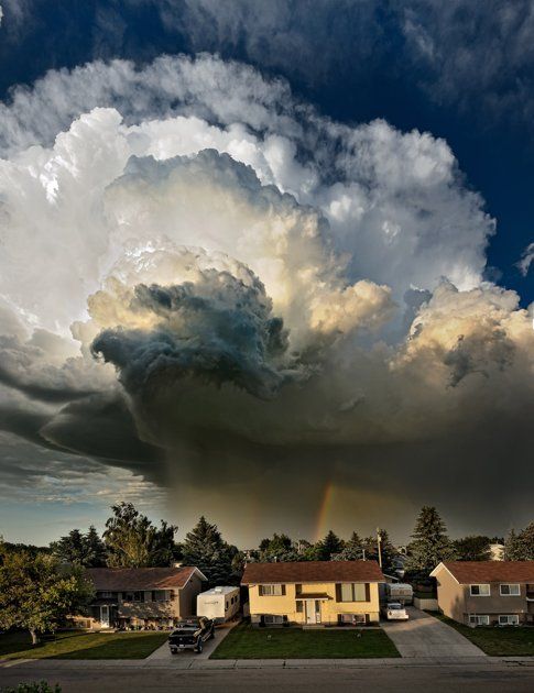 This is the moment a cloud threatened to develop into a full blown TORNADO over a row of family homes. Brave snapper Pat Kavanagh took this shot of an explosive black storm from the roof of his house in Taber, Canada last month. Expecting the sunny weather to take a turn for the worse he watched intently as the billows started spinning into a furious funnel.