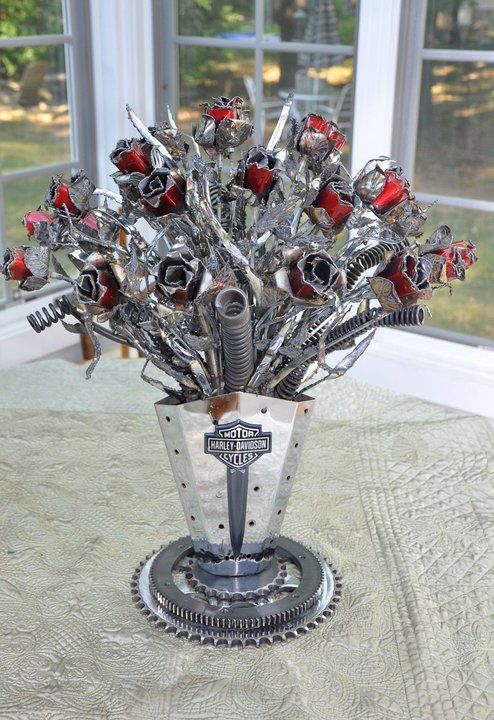 Vase of flowers made entirely from motorcycle parts. This one is for that friend ;)
