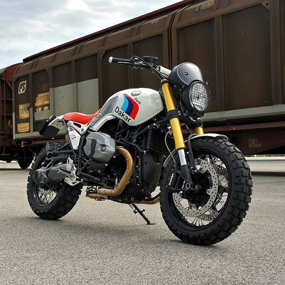 Word on the street is that BMW will soon launch a scrambler version of the R nineT. We're hoping it looks as good as this Dakar-themed custom from @Luis Moto of Italy. He’s reworked the R nineT into a modern version of the iconic R80G/S Paris Dakar, complete with motorsport graphics and that classic red seat. And the stainless steel, two-into-one exhaust system is absolutely … Fantastisch. #MakeLifeARide #scrambler Get the full specs and high-res images at
