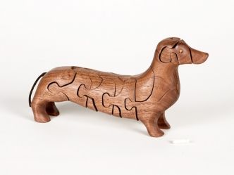 3-D Dachshund Puzzle by Peter Chapman: Handcrafted of a single piece of walnut or paduak, this lovely dog has a bone tucked inside! 10 x 2 x 5