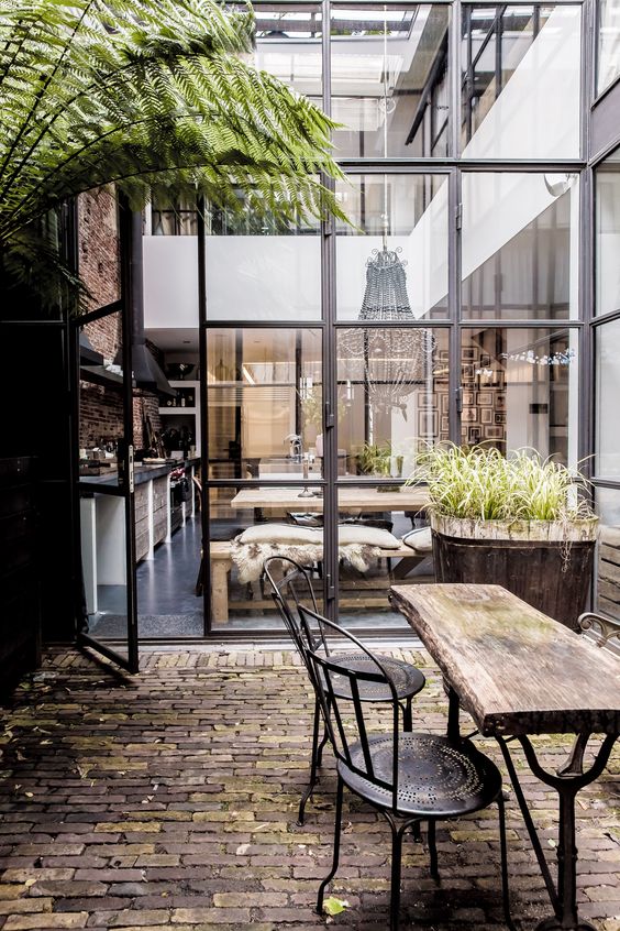 Amsterdam : Warehouse loft balcony. / Le loft familial de Marius Haverkamp. I really like the rustic industrial look but I would want it out in the country, not the city. Love that wood plank and pipe table.