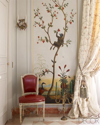 An 18th-century painted chinoiserie panel and gilded-bronze candelabra in the dining room.