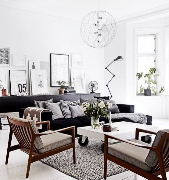 An Airy Scandinavian Interior Design for Your Neutral Living Room : Fashionable Design For White Living Room With Black Modern Sofa And Wooden Armchairs Also White Coffee Table On Wheels