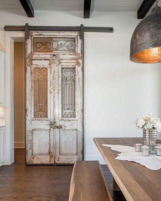 Antique french doors and transom used to create a sliding barn door