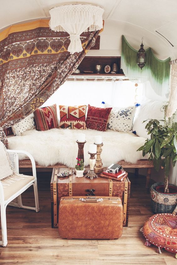 Beautiful living room decor - patterned pillows, lots of candles and vintage furniture.