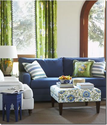 blue sofa, green curtains, & patterned ottoman with fabric by calico corner