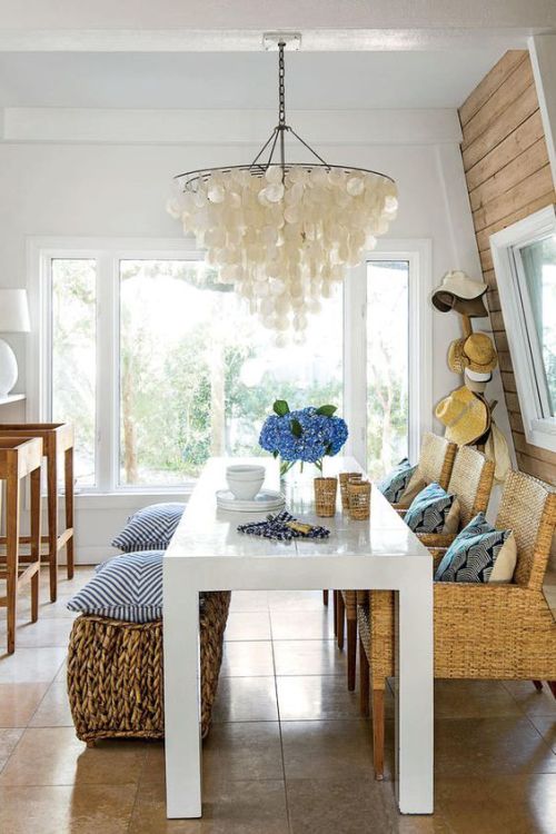 Coastal dining room with a shell chandelier