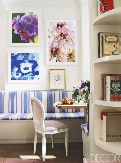 Designer Philip Gorrivan upholstered the breakfast-area banquette of Manhattan-based filmmaker Nathaniel Kramer's Upper East Side apartment in a cheery blue-and-white DeLany & Long awning stripe. Photographs by Kramer and an artist's proof by Joan Miro adorn the walls.