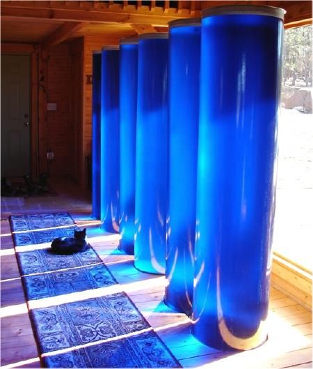 Fiberglass passive solar heat water storage tubes in a trombe wall installation