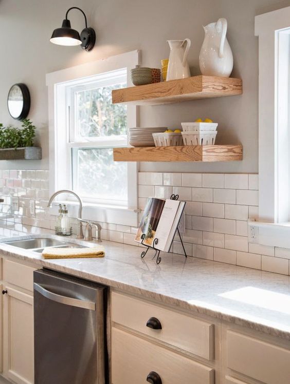 gooseneck lamp, white kitchen cabinets, white subway tile and walls painted Sherwin Williams Mindful Gray, open shelving