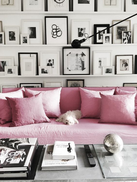 great idea for a gallery wall - floating shelves - delicate black and white frames against the pink/lavender couch feels so very pretty too.