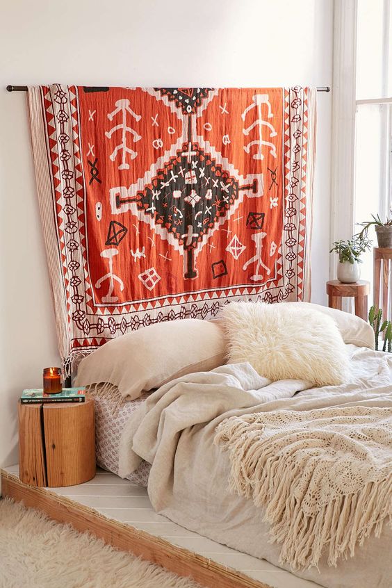 I like the idea of a rod above the bed and you can just hang a tapestry or blankets