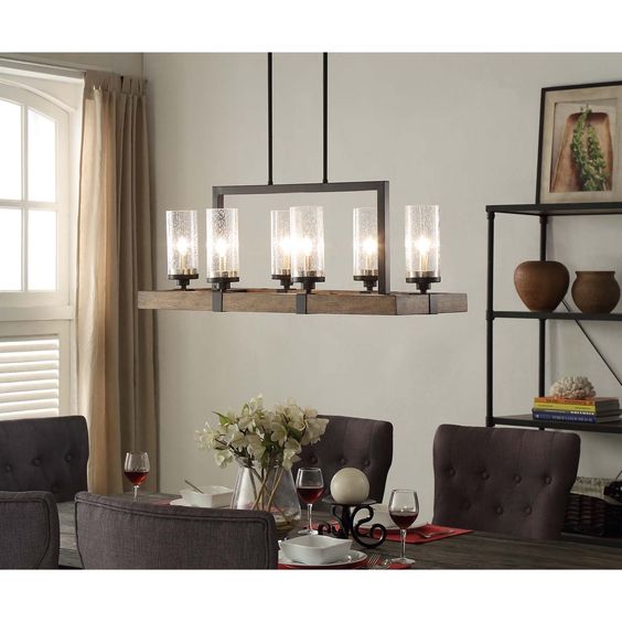Illuminate your home with the rustic charm of the Vineyard 6-light Metal and Wood Chandelier. This unique light fixture features a rectangular shaped frame made of warm brown wood that is accented by black metal and glass shades.