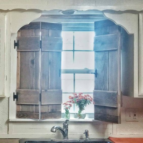 | kitchen | shutters | farmhouse style | vintage inspired | wood | diy | cottage kitchen | kitchen window | faucet | natural sun light |flowers in Mason jar