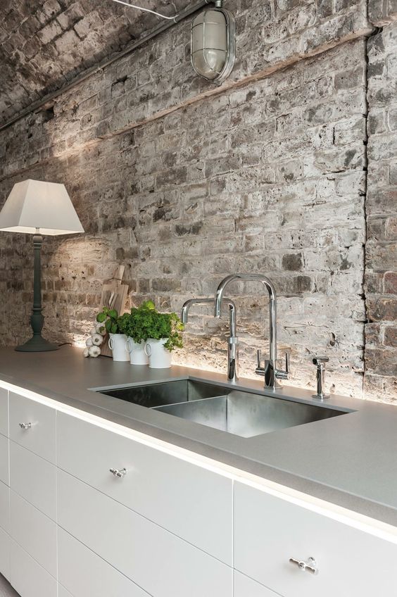 kitchen with brick wall and grey countertop ***