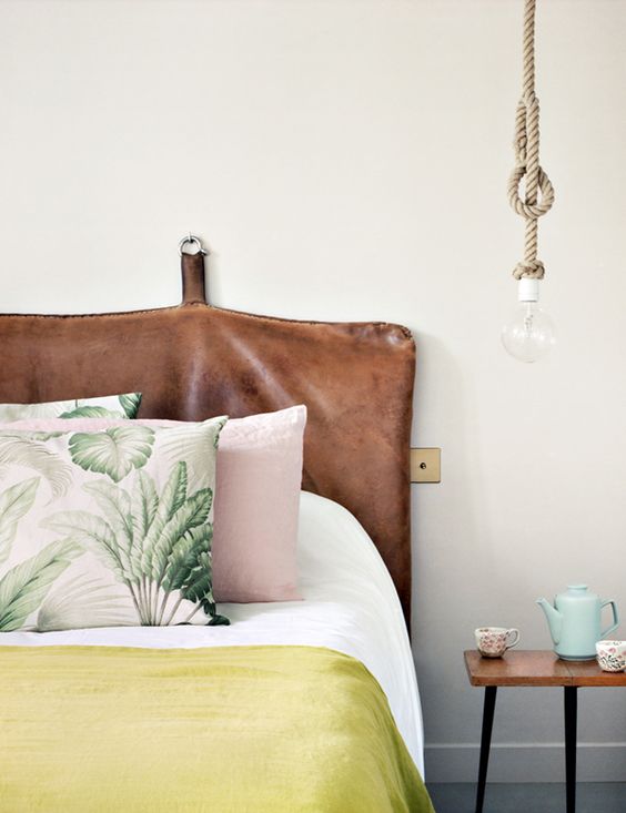 leather headboard with tropical colors and pillows in the bedroom, gorgeous combo!