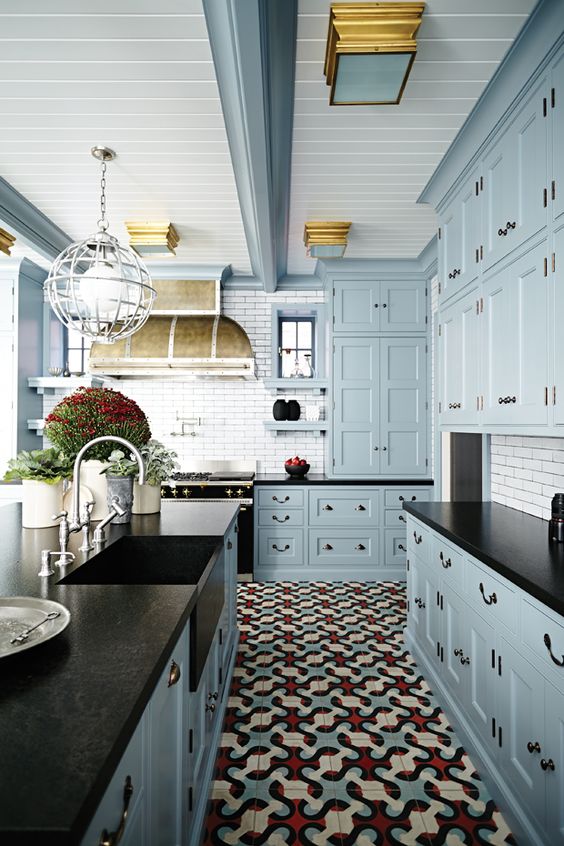 Light blue kitchen cabinets, black countertop