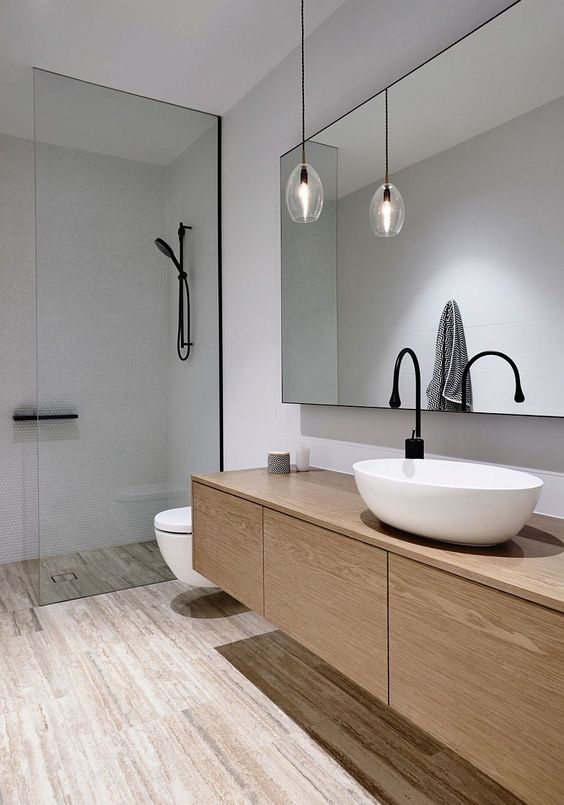 Lighting inside the white contemporary bathroom is kept minimal - Decoist