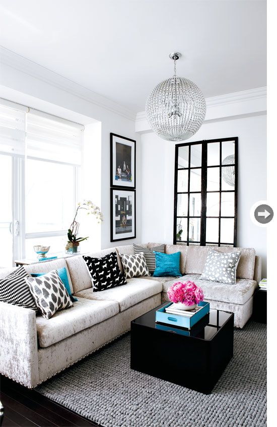 Living room Even the crushed velvet sofa style she’s sitting on has bling – silver nailhead detailing added by Stacey outlines its base, while, above it, a dazzling light fixture emphasizes the condo’s 10-foot ceilings.