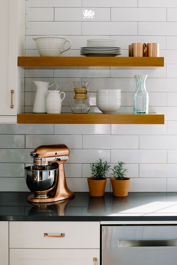 Love open shelving but not sure how to make it work for your kitchen? One of the easiest ways to keep the look in line is by displaying only those items you truly love. Odds are, you use them so often already that a door-less shelf makes them that much more convenient. [Featured Design: Fieldstone™]
