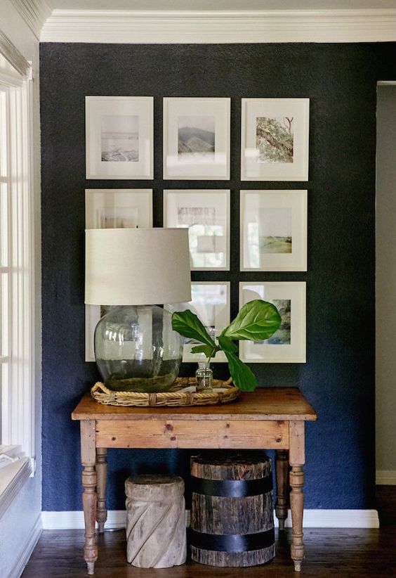 love this dark accent wall + the way the photos are displayed