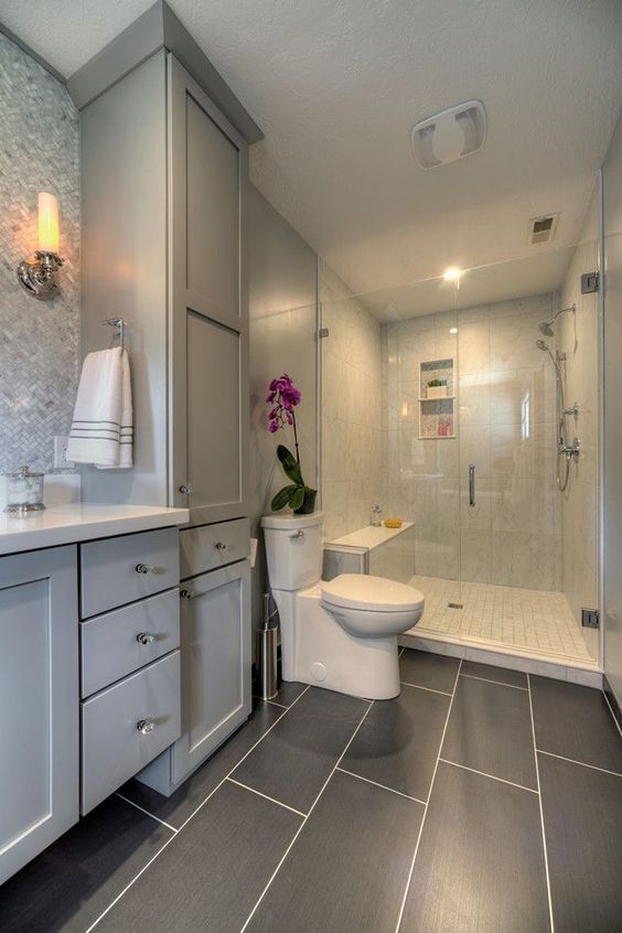 Master bathroom with glass walk in shower, large gray tiles on floor, gray cabinets, mosaic tile backsplash | yaminidesigns, llc