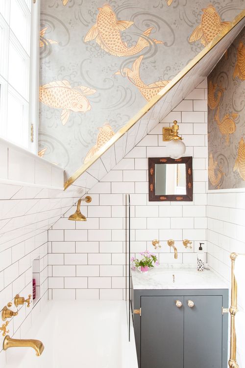 Metro tiles, brass taps and Osborne & Little koi carp fish wallpaper in The Pink House bathroom