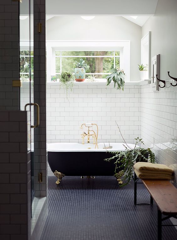 navy tiles, black clawfoot tub, and white subway tile