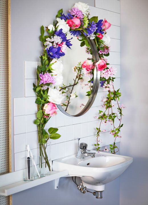 Picture of a garland of flowers around a bathroom mirror
