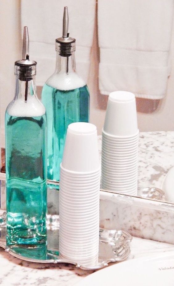 Put mouthwash in a container, with cups and on a cute tray for your bathroom sink. Genius.