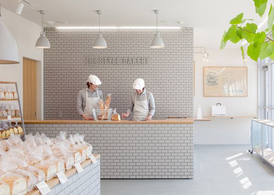 Renovated Japanese bakery featuring tiled walls and oak shelving.