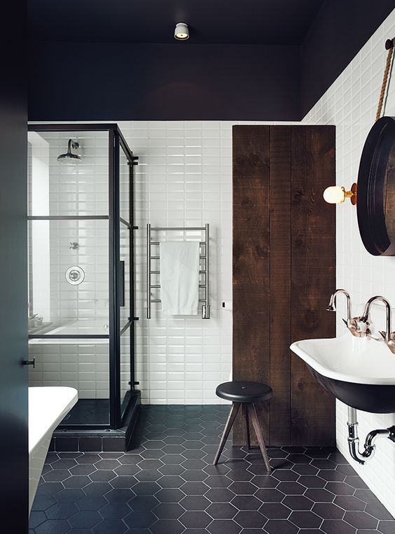 Renovated Montreal bathroom with black and white Ceragres tiles.