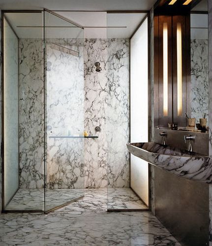 satin brass shower detailing, and look at that marble with the etched glass wall over the window