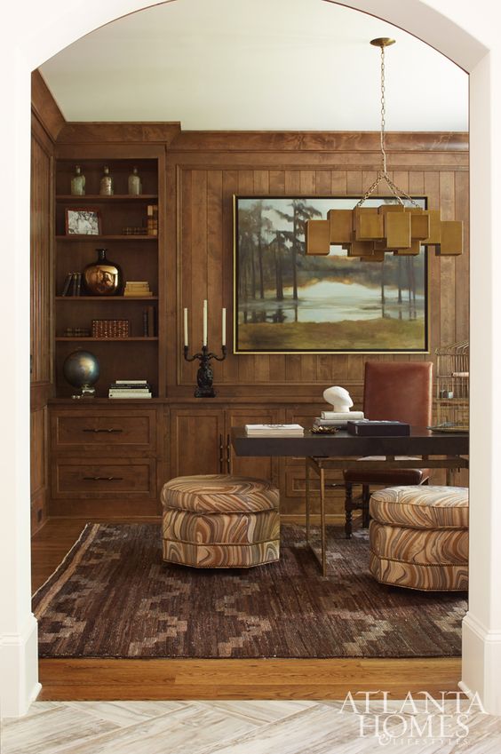 Shayelyn selected a dusky, agate-inspired fabric by Kelly Wearstler for the ottomans to contribute to the masculine but sexy vibe in her husband’s office/ An equally stunning Moattar rug features a tribal pattern. Light fixture, Mitchell Gold   Bob Williams. Desk, Julian Chichester. The custom artwork is by Donna Hughes.